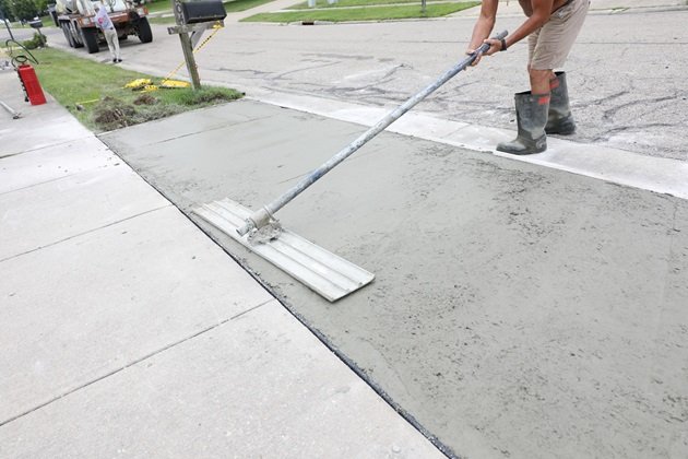 Concrete driveway being resurfaced to fix widespread surface damageConcrete driveway being resurfaced to fix widespread surface damage