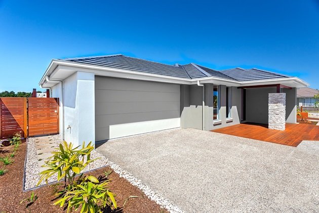 Sleek exposed aggregate driveway leading to an Ipswich home