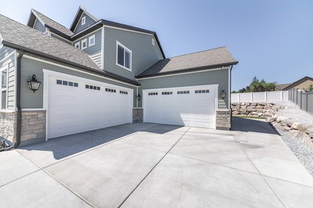 Modern concrete driveway leading to a contemporary Ipswich home